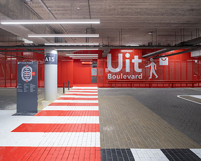 XML uses bright red accents to facilitate orientation within parking garage in amsterdam