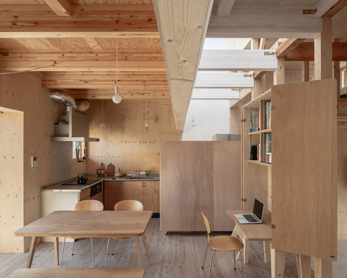 yoshichika takagi renovates two-storey sapporo residence with curved white wall insertion
