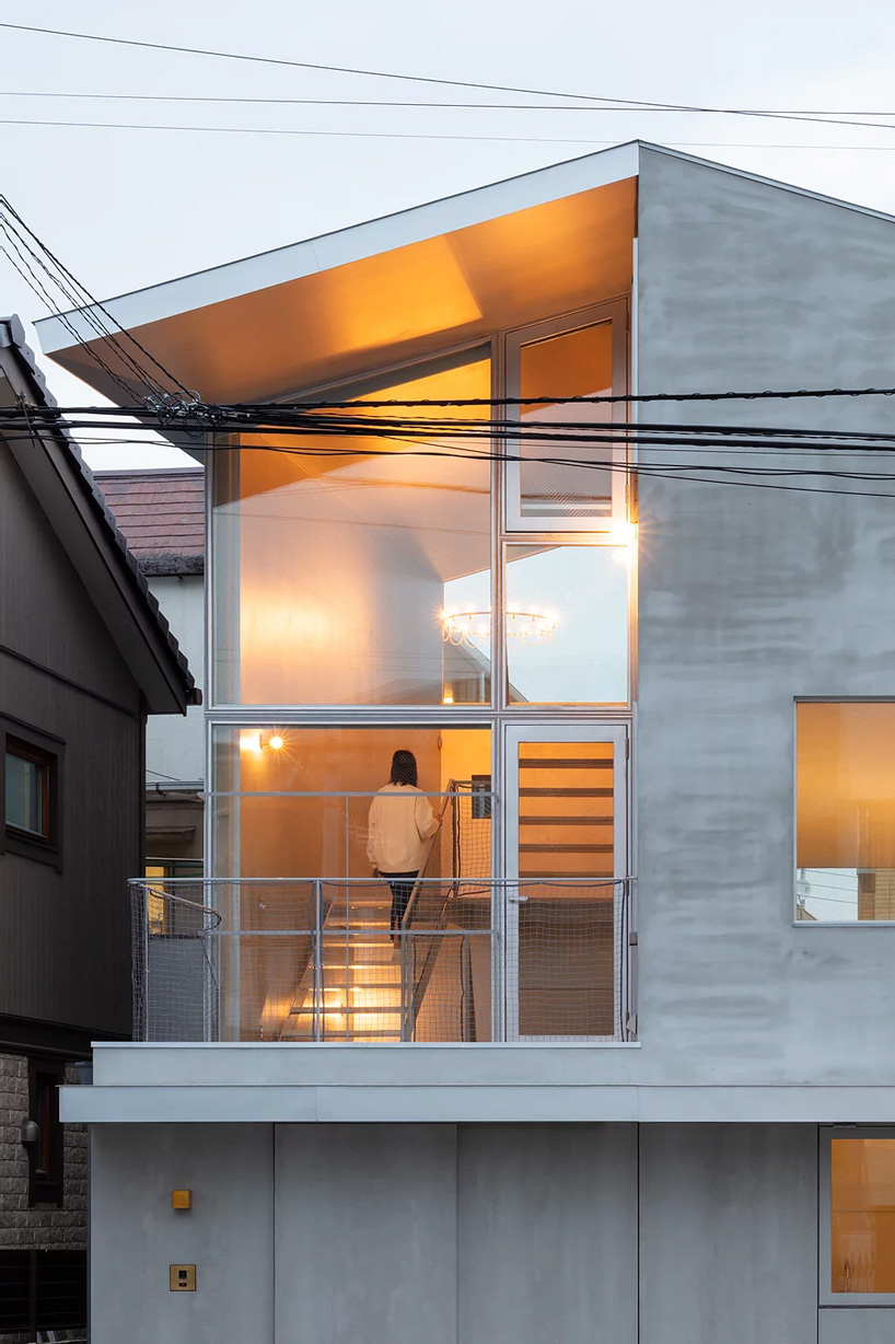 atelierco architects' 'brass house' in tokyo is split in two halves