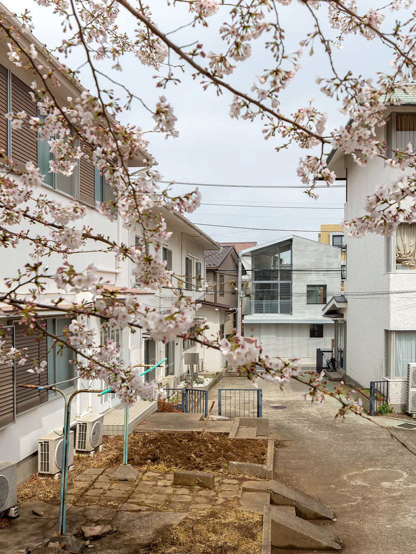 atelierco architects splits 'brass house' in tokyo in two symmetrical halves