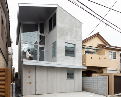 atelierco architects splits 'brass house' in tokyo in two symmetrical halves
