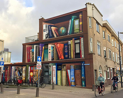 dutch street artist paints a massive bookcase on a three-level building in utrecht