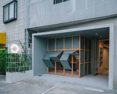 fathom clads japanese hair salon in façade of galvanized iron folding screens