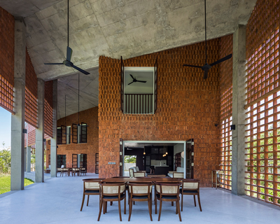 a porous brick façade surrounds G8A's 'tropical chalet' in da nang, vietnam