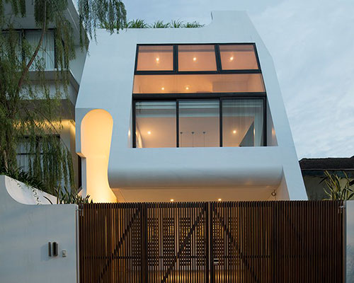 graphic white volumes and open courtyards build family residence in jakarta