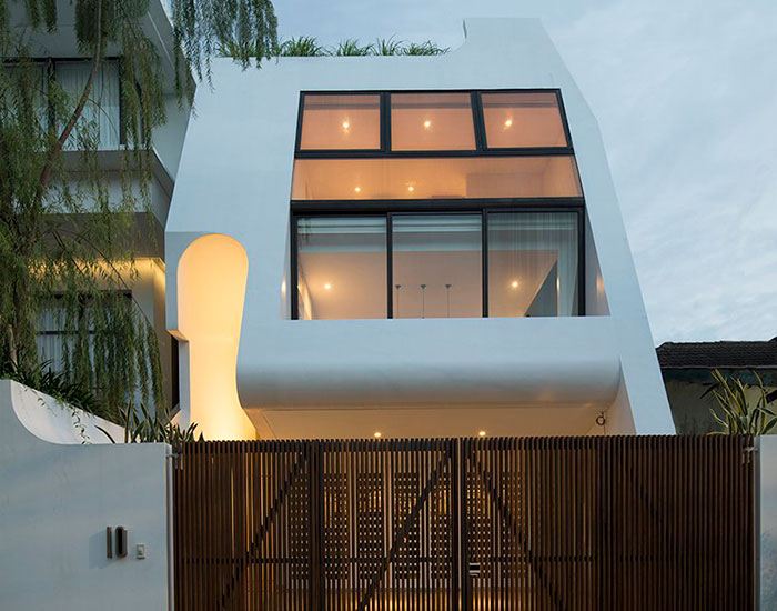 graphic white volumes and open courtyards build family residence in jakarta