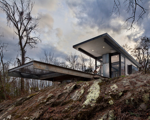cantilevered hammock completes the off-grid 'lost whiskey' cabin by greenspur in the US