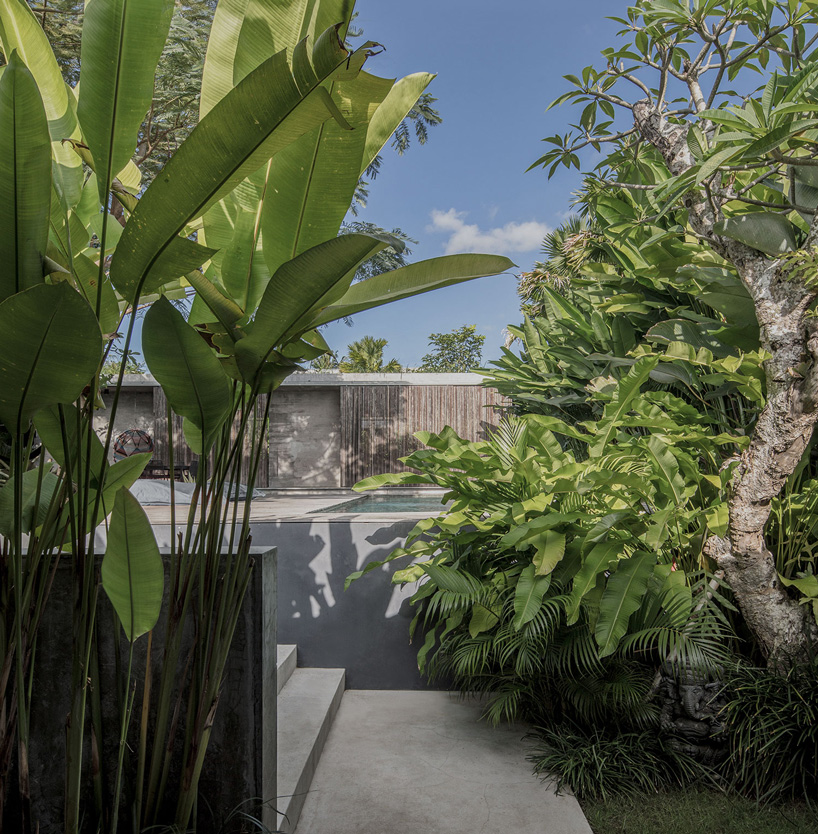 caceres + tous sets exposed concrete 'house BK' amid bali's lush natural landscape