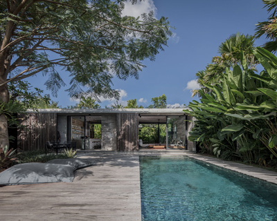 caceres + tous sets exposed concrete 'house BK' amid bali's lush natural landscape