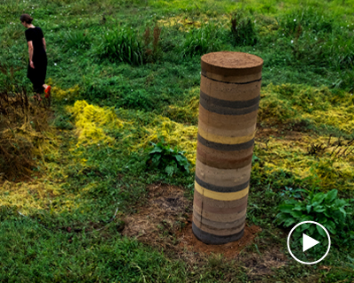 pillars made from the biomass of dead palm trees populate a riverside site in portugal