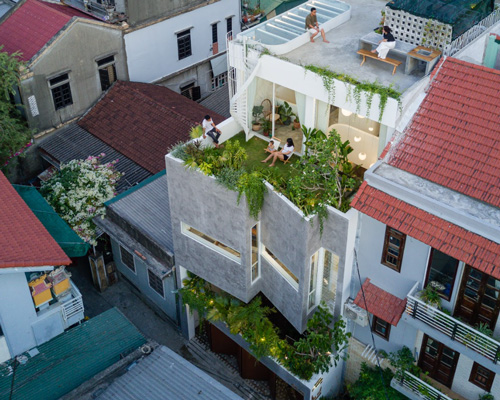 limdim house studio inserts plant-filled ventilation gap in this narrow house in vietnam