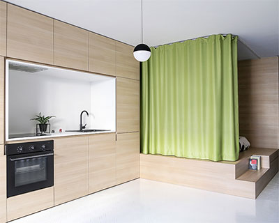 lime curtains define space and provide privacy within small apartment interior in paris