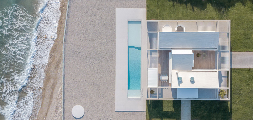 top view of r.c. tech's white monolithic beach house by the coast of northern peloponnese, greece