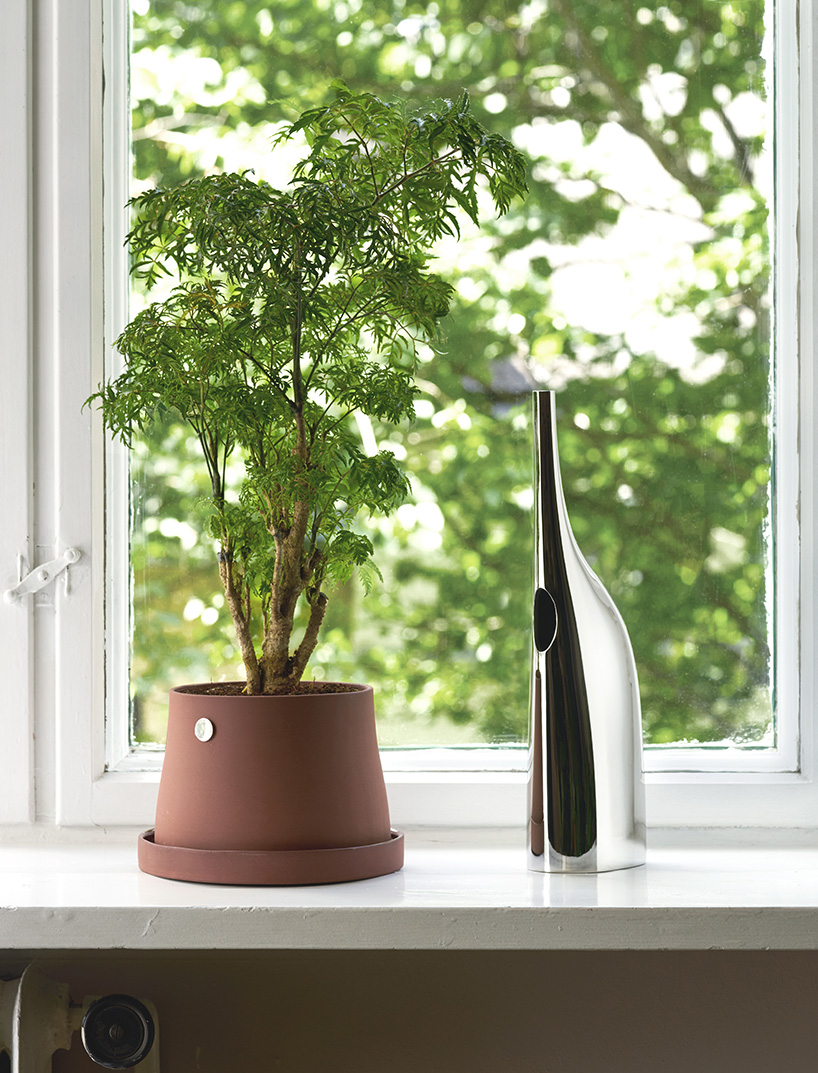 snøhetta's terra is a plant accessory series in terracota & stainless steel for georg jensen