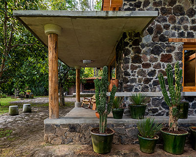 stone, adobe, and concrete form country house by luis carbonell in mexico