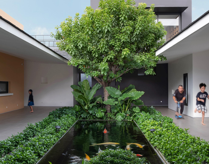 TAA design develops house in vietnam around central, tree-planted courtyard