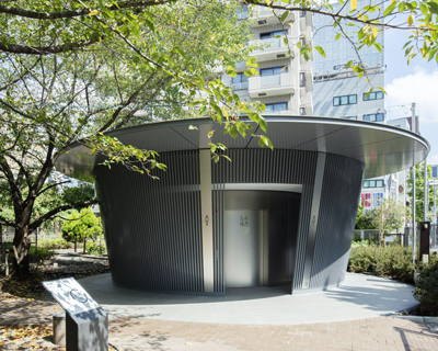 tadao ando contributes to the tokyo toilet project with a cylindrical, louvred volume