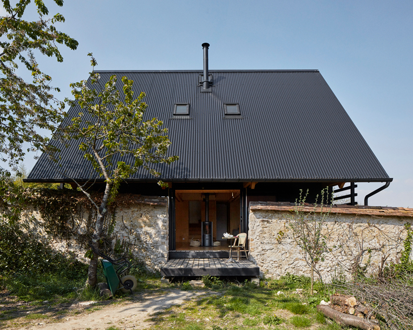 arba builds a timber house between two old stone walls in rural france - 1