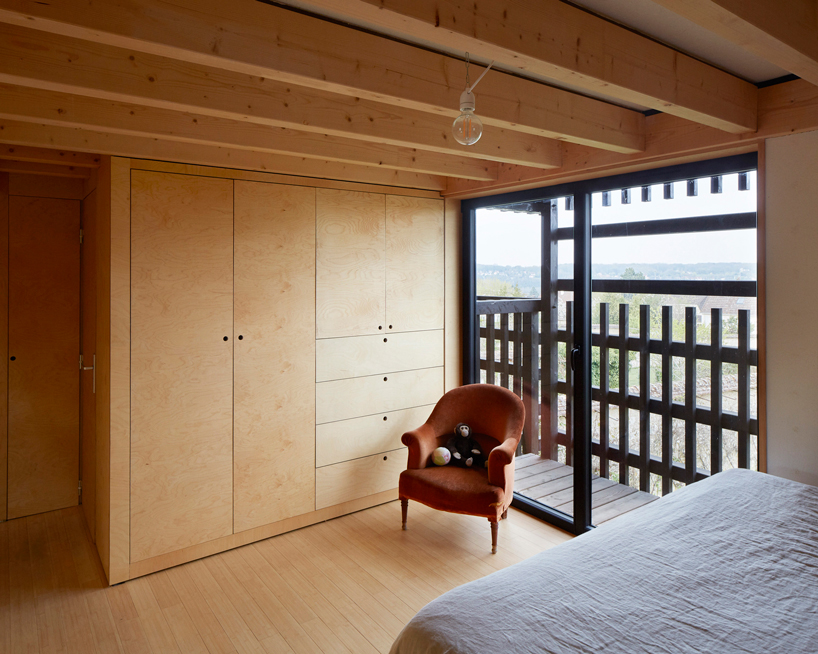 arba builds a timber house between two old stone walls in rural france - 12