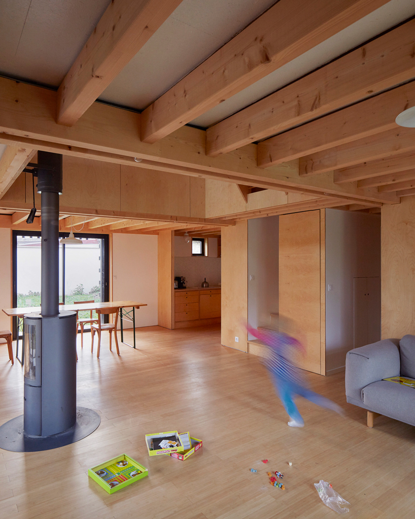 arba builds a timber house between two old stone walls in rural france - 6