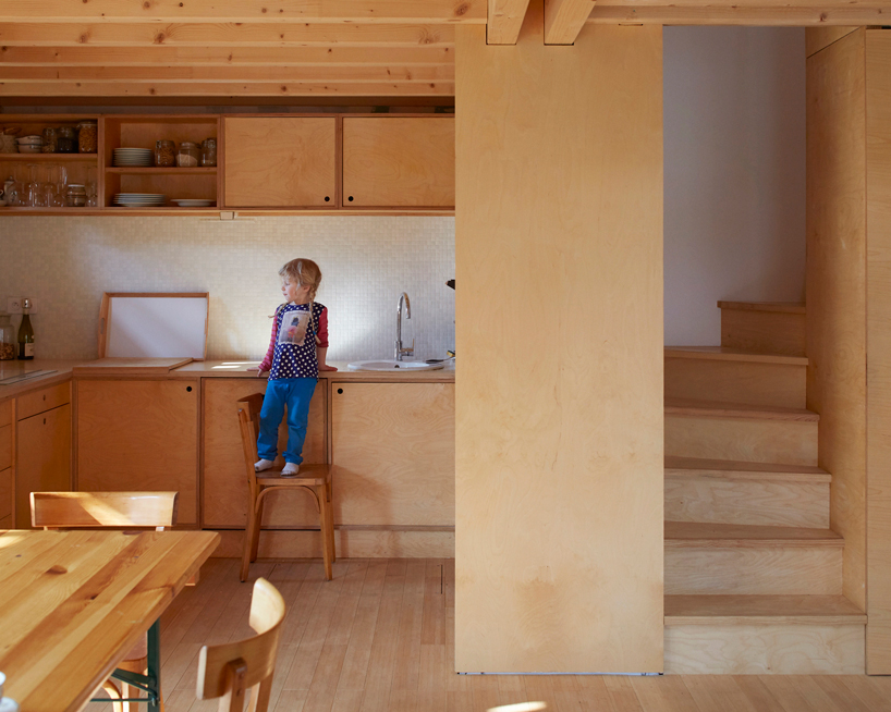 arba builds a timber house between two old stone walls in rural france - 8