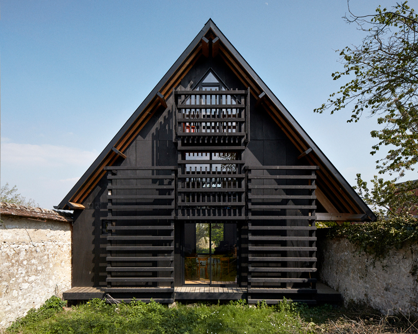 arba builds a timber house between two old stone walls in rural france - 2