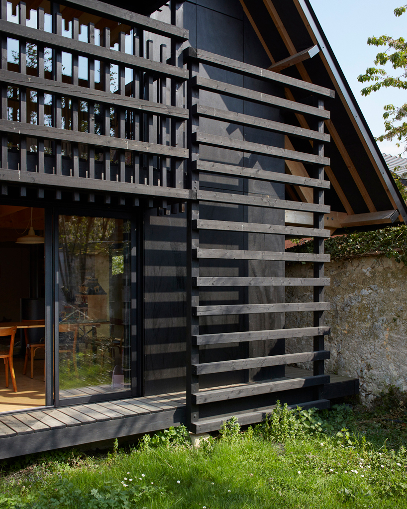 arba builds a timber house between two old stone walls in rural france - 4