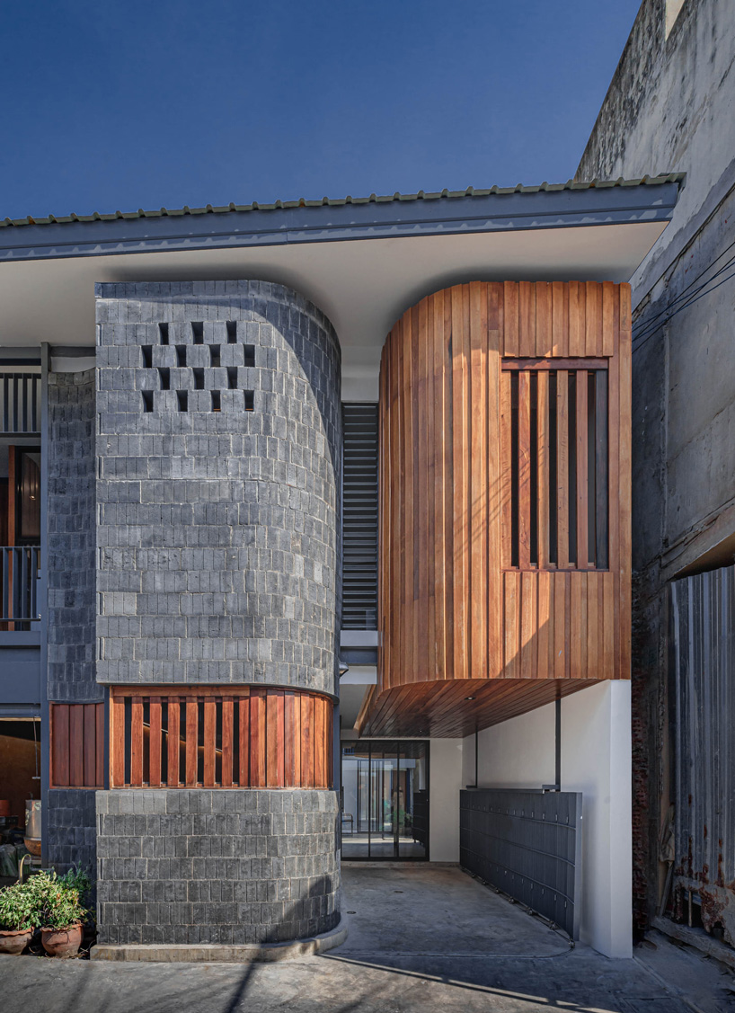 brick and wood facade in bodinchapa architects' house + family business building in thailand