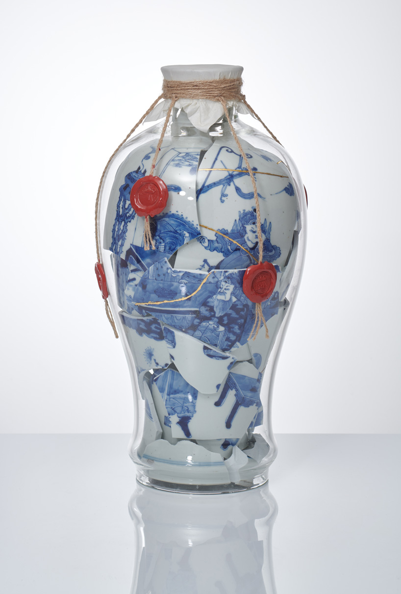contemporary glass following the original form of its contents; 18th century qing dynasty chinese porcelain vase with parchment paper cover