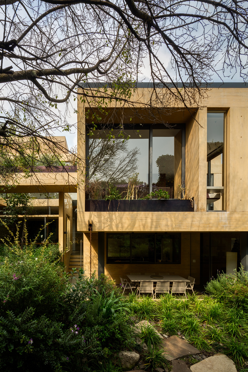 floor to ceiling window and yellow-toned concrete