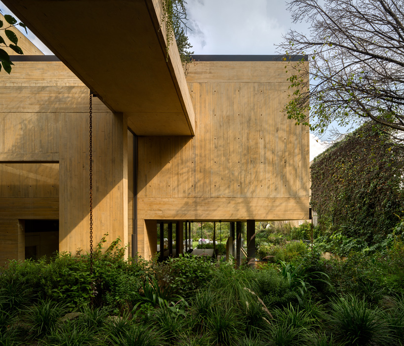 exterior view of yellow-toned concrete building estudio MMX CBC house