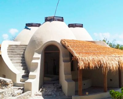 eco-village of clustered 'lombok domes' accumulates along indonesian coastline