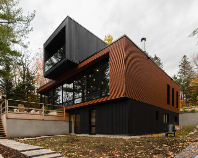 figurr architects collective stacks five prefab custom modules for house in québec, canada
