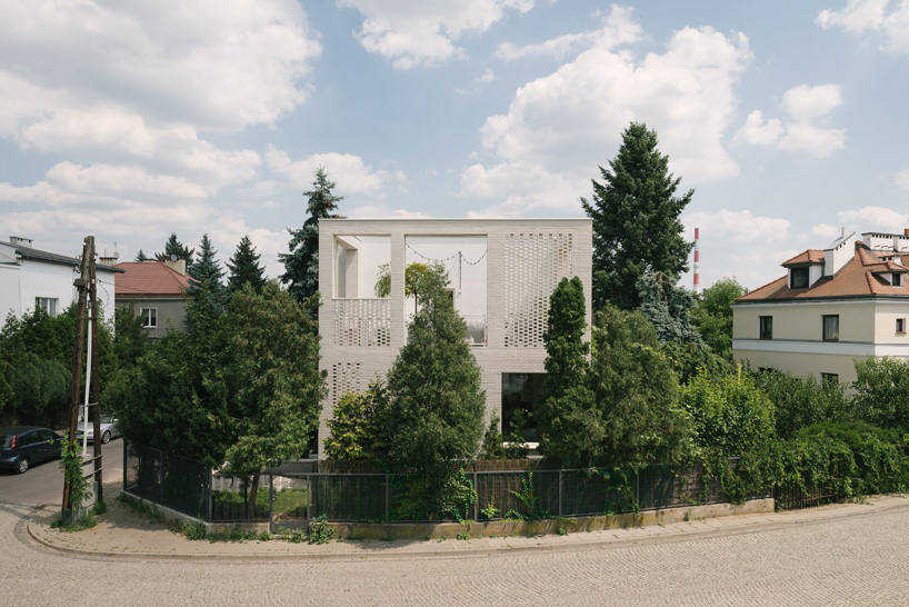 MFRMGR architects adds perforated white-brick frame to 1970s terrace house in poland
