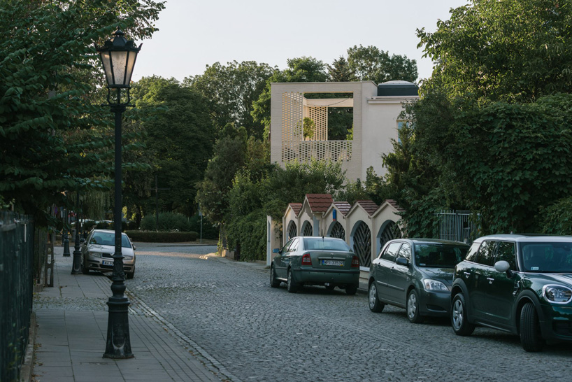 MFRMGR architects adds perforated white-brick frame to 1970s terrace house in poland