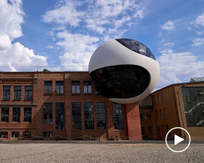 oscar niemeyer’s vision for a concrete and glass sphere is realized in leipzig, germany