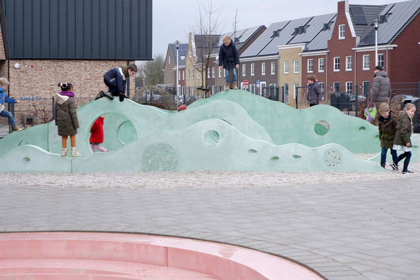 children playing on the undulating landscape of concrete elements