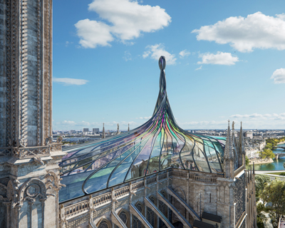 a stained glass roof twists into a spire for this alternative vision of notre dame cathedral