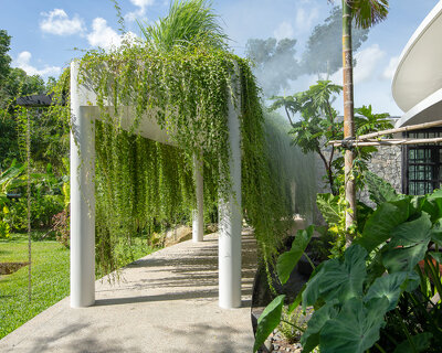 a curved roof garden tops 'the breeze house' by UAD architects in cambodia