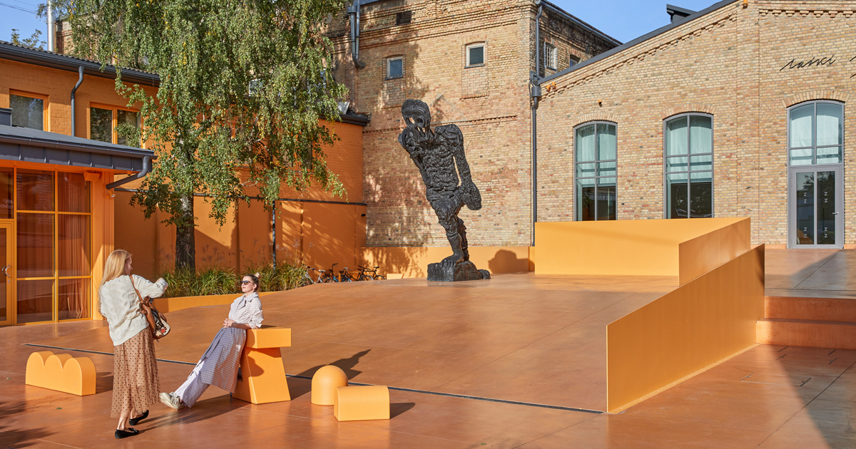 energetic orange adorns the zuzeum art center in riga, designed by