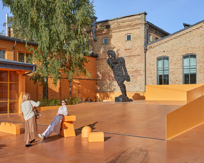 energetic orange adorns the zuzeum art center in riga, designed by annvil