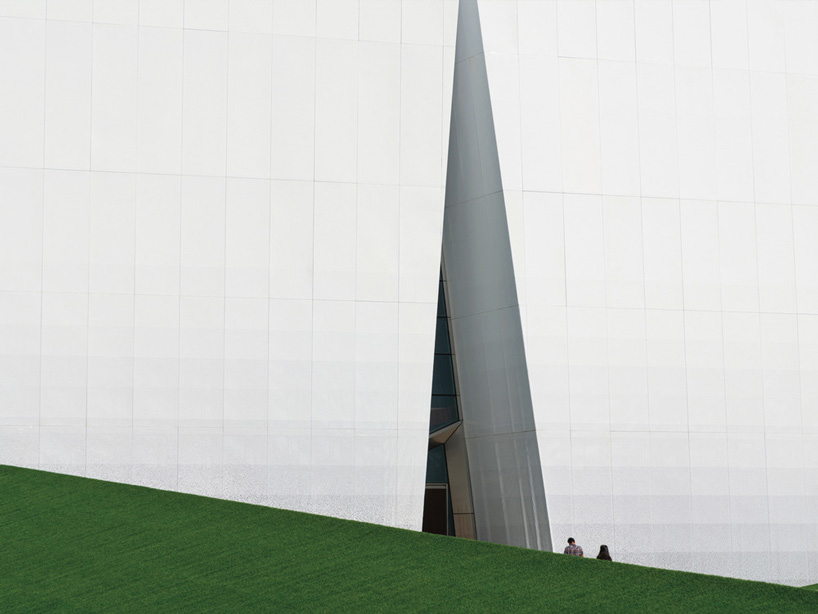 exterior triangle-shaped entrance of shuifa info town property exhibition center in china by aoe