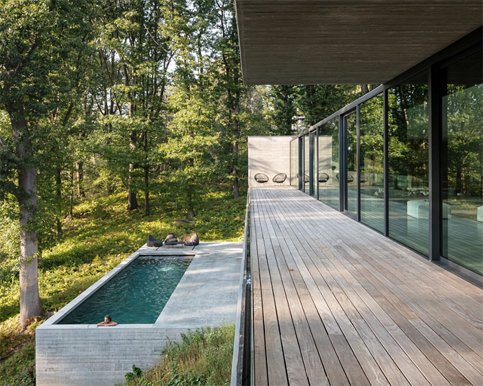 linear concrete residence by govaert & vanhoutte architects blends in belgian forest