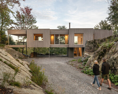 natalie dionne architecture embeds wooden house into rocky canadian forest