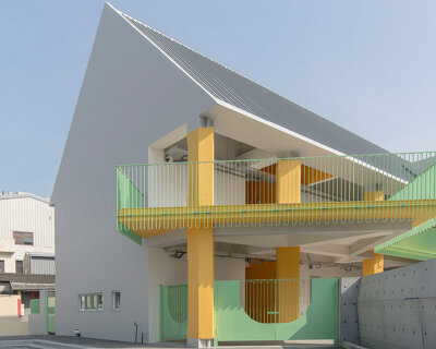 bright yellow columns complete ospacearchitects' tung yuan kindergarten in taiwan