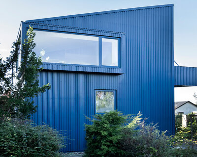 sigurd larsen clads monolithic danish house in blue corrugated steel