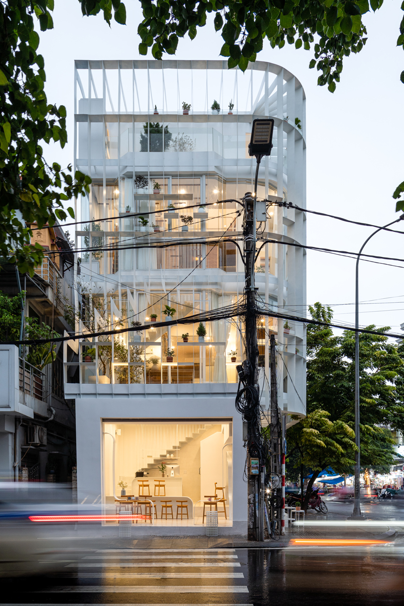 NKAA stacks a café and family home onto a corner site in hue, vietnam designboom