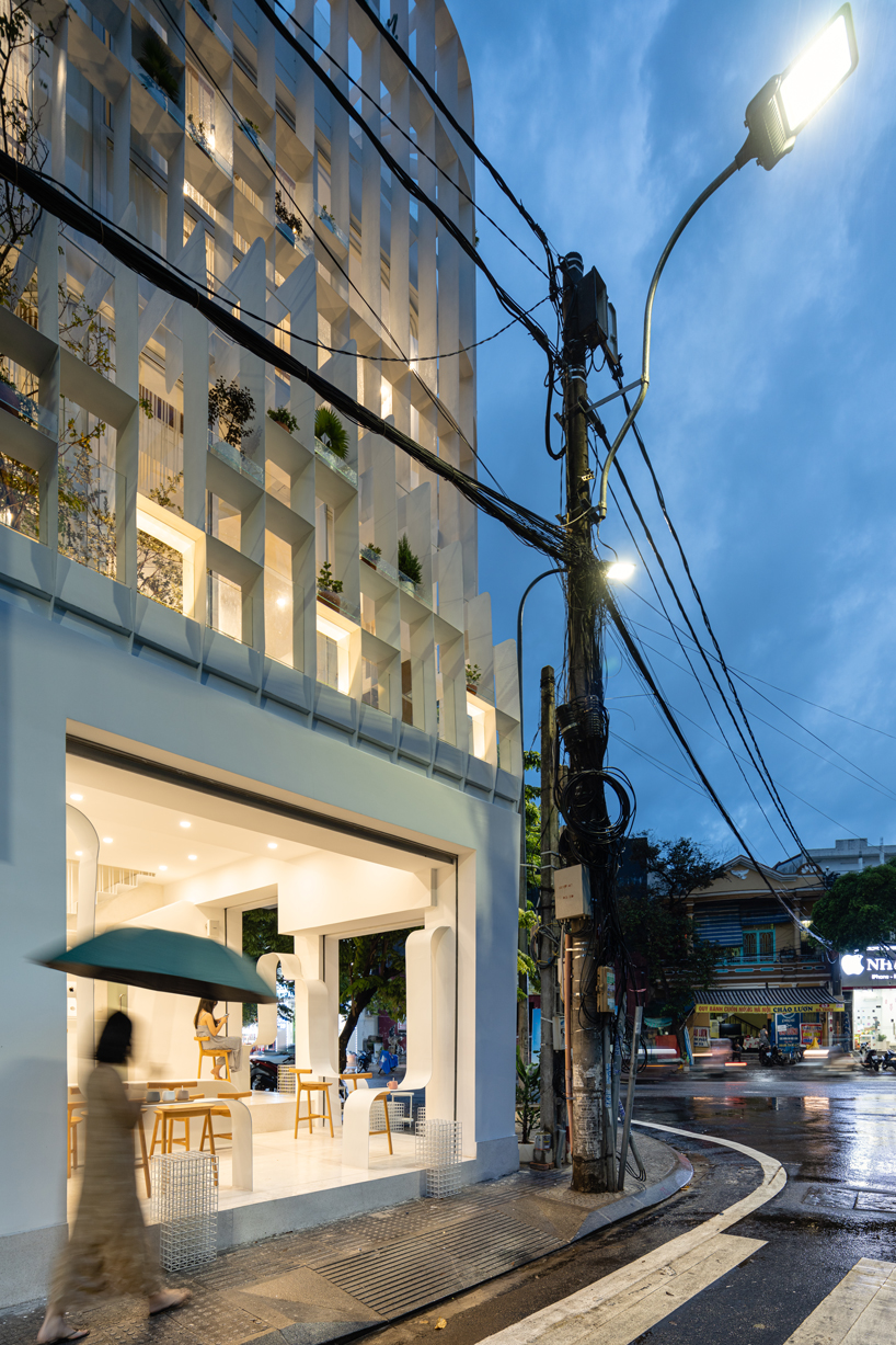 NKAA stacks a café and family home onto a corner site in hue, vietnam designboom