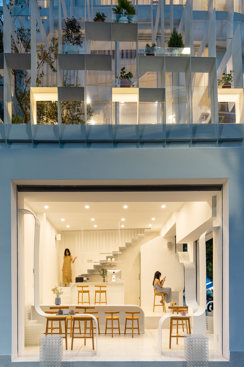 NKAA stacks a café and family home onto a corner site in hue, vietnam designboom