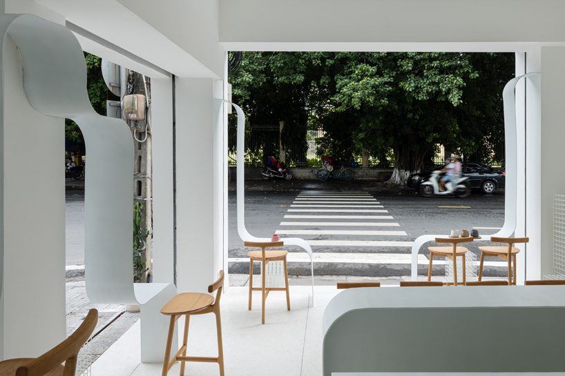 NKAA stacks a café and family home onto a corner site in hue, vietnam designboom